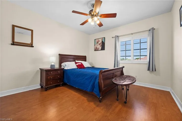 Bedroom featuring wood-type flooring and ceiling fan