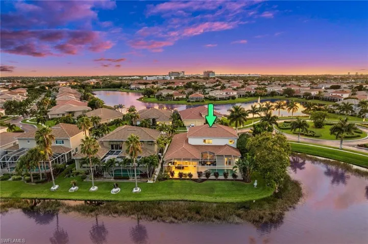 Aerial view at dusk featuring a water view