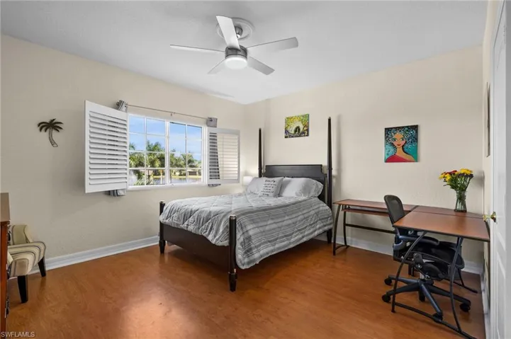 Bedroom with hardwood / wood-style flooring and ceiling fan