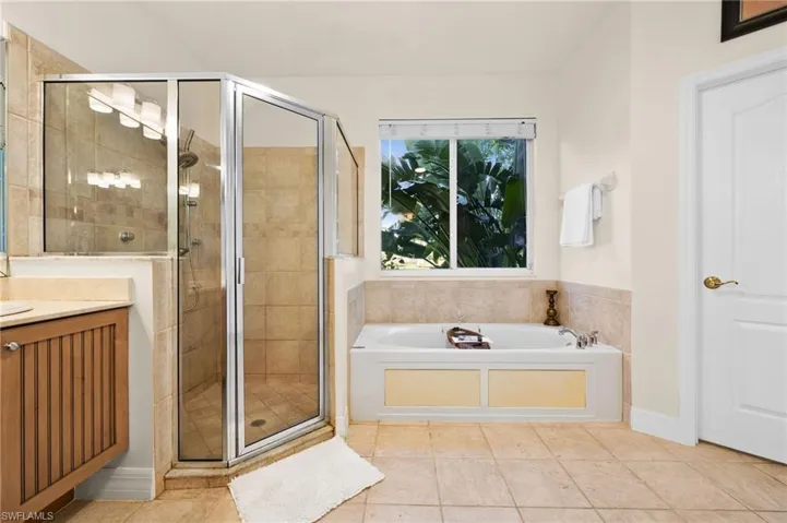 Bathroom featuring independent shower and bath, tile patterned floors, and vanity