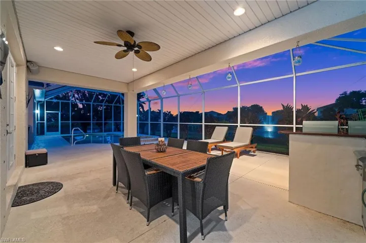 Welcome to the beautiful pool deck  terrace at dusk, spacious seating areas, ceiling fans and beautiful lighting.