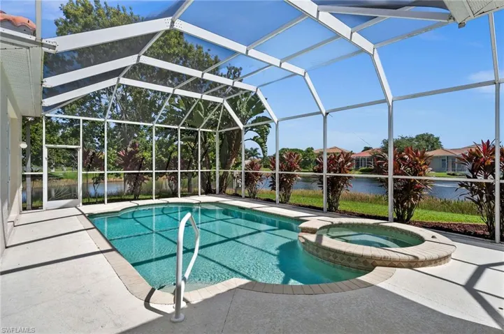 View of pool with a patio, an in ground hot tub, and a lanai