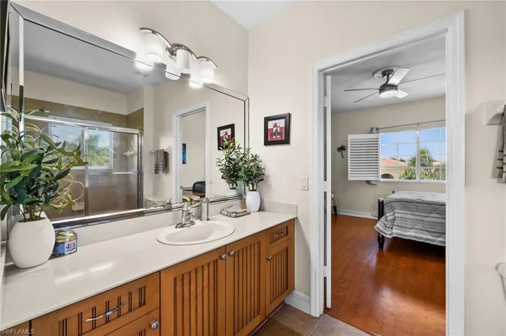 Bathroom featuring vanity, tile patterned flooring, and ceiling fan