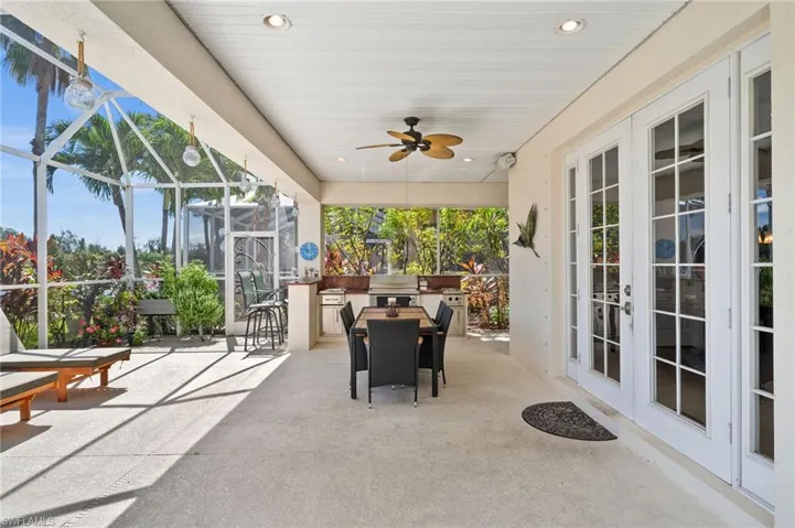 Outdoor deck featuring french doors and ceiling fan and summer kitchen in the back!