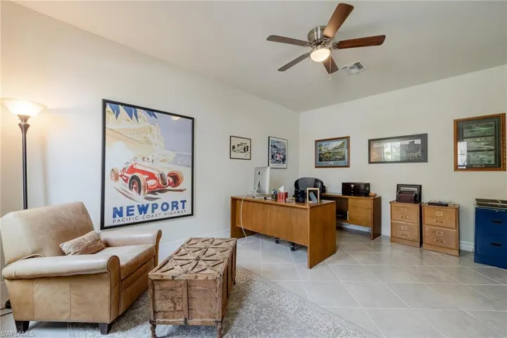 Office space with ceiling fan and light tile patterned flooring