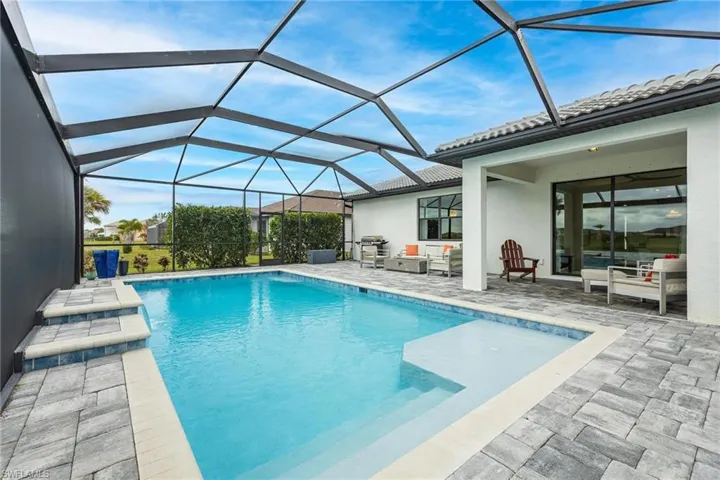 View of swimming pool with a patio area and a lanai