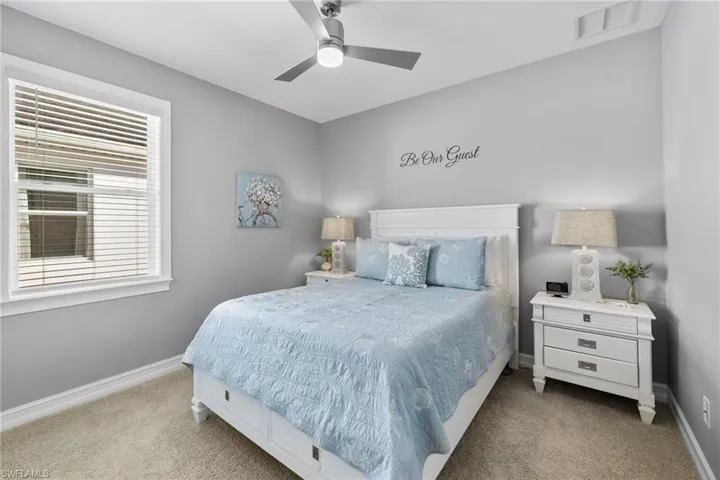 Carpeted bedroom with ceiling fan