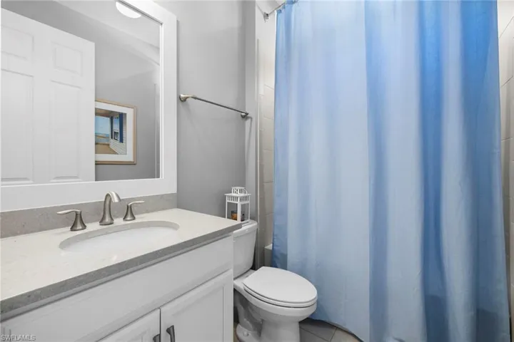 Bathroom featuring tile patterned floors, vanity, and toilet