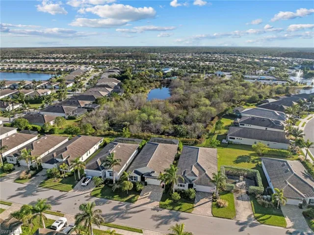 Birds eye view of property with a water view