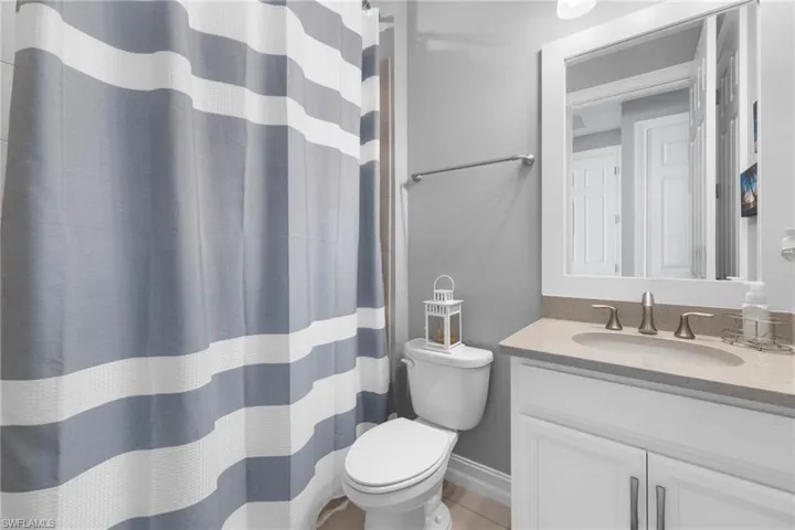 Bathroom featuring tile patterned flooring, vanity, and toilet