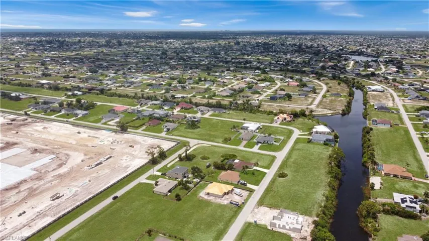 Aerial overview of property's location featuring a large body of water and nearby suburban area