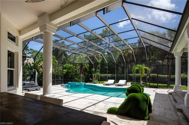 View of swimming pool with a lanai, an in ground hot tub, and a patio area