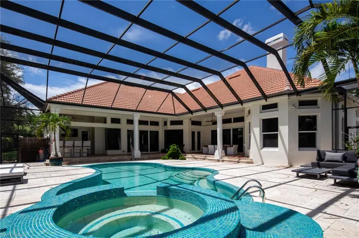View of swimming pool with a patio area, a lanai, ceiling fan, and an in ground hot tub