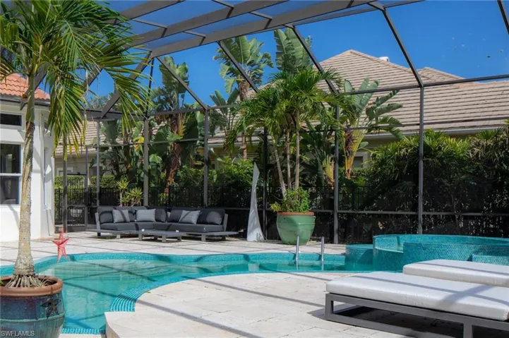 View of swimming pool with a patio, glass enclosure, and an outdoor living space