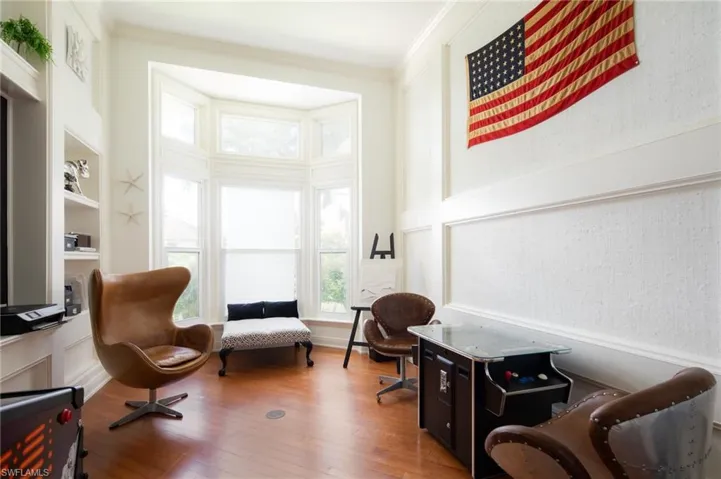 Living area featuring hardwood / wood-style flooring and ornamental molding