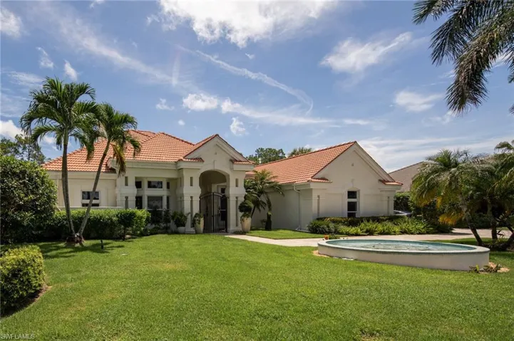 Mediterranean / spanish-style house with a front yard