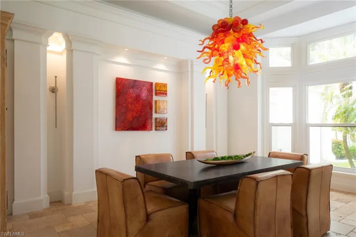 Dining room with decorative columns and ornamental molding