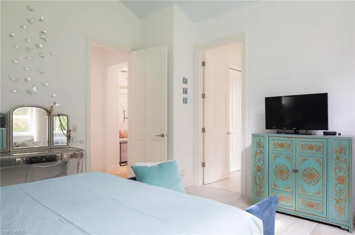 Bedroom featuring light wood-type flooring and lofted ceiling