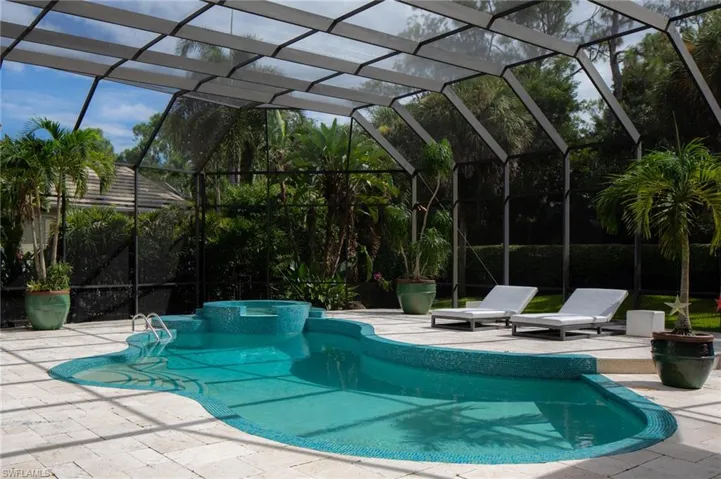 View of swimming pool with a patio and a lanai