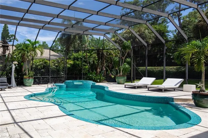 View of pool featuring a patio, a lanai, and an in ground hot tub