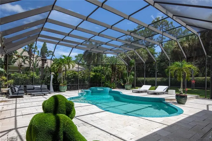 View of pool with a lanai, a patio, and an outdoor hangout area