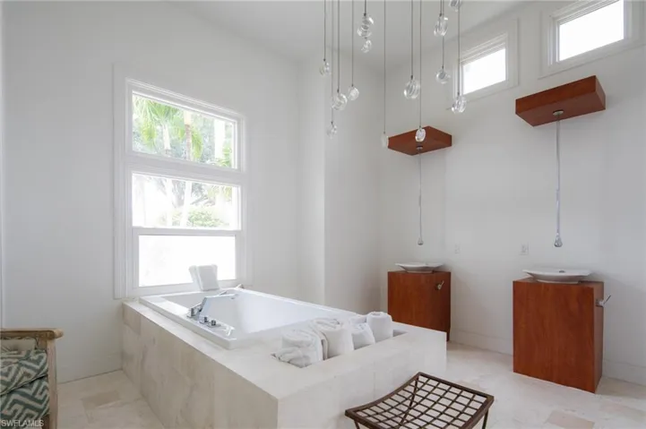 Bathroom featuring vanity and tiled tub