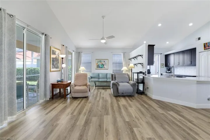 Sitting room featuring ceiling fan, light hardwood / wood-style flooring, and vaulted ceiling