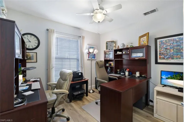 Office with ceiling fan and light hardwood / wood-style floors