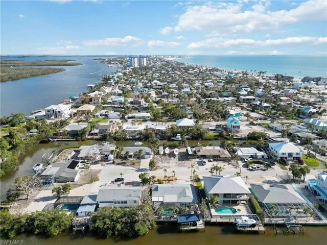 Birds eye view of property with a water view
