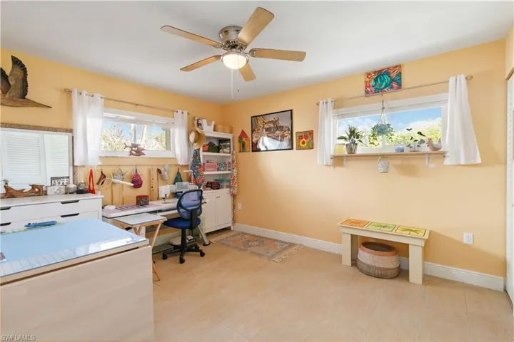 Office featuring a ceiling fan and baseboards