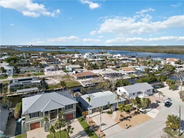 Drone / aerial view with a water view and a residential view