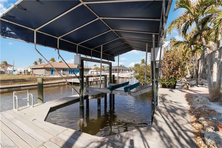 Dock area featuring a water view and boat lift