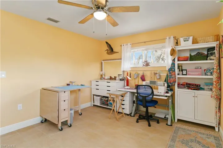Home office with visible vents, ceiling fan, and baseboards