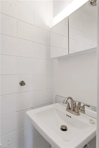 Bathroom with concrete block wall and a sink