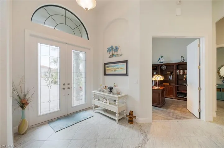 Entryway featuring french doors and a towering ceiling