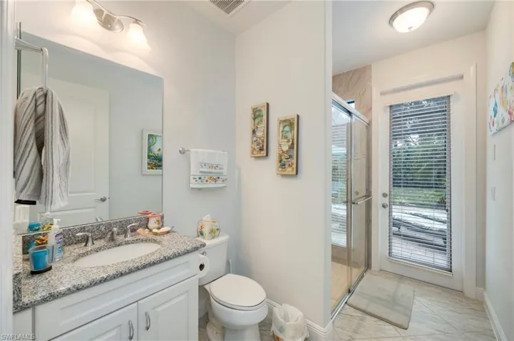 Bathroom featuring vanity and a stall shower