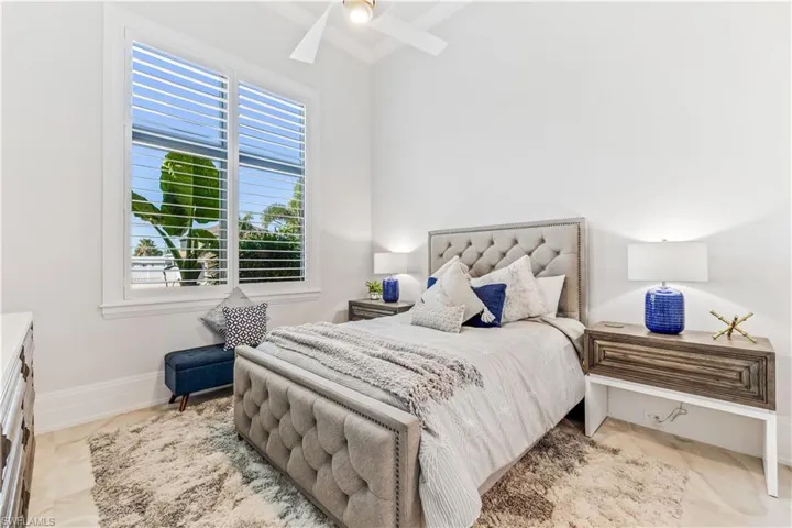 Bedroom with multiple windows and ceiling fan
