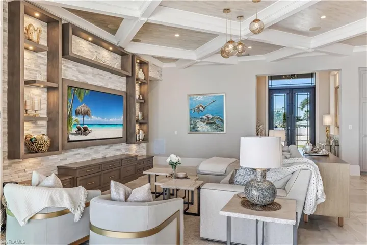 Living room with beamed ceiling, french doors, and coffered ceiling