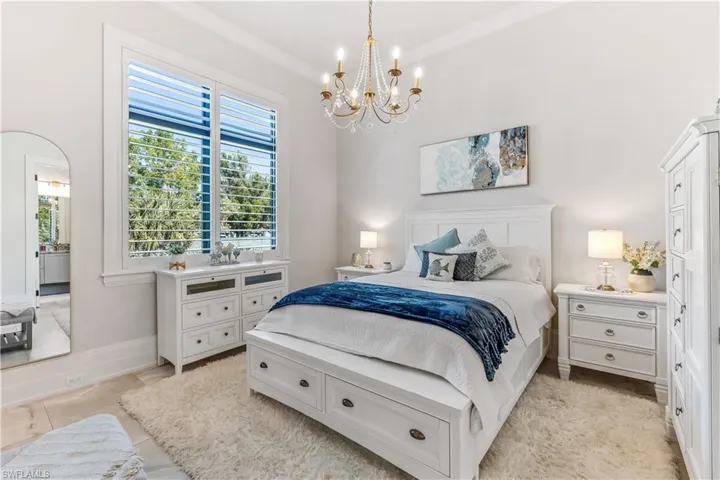 Tiled bedroom with a chandelier