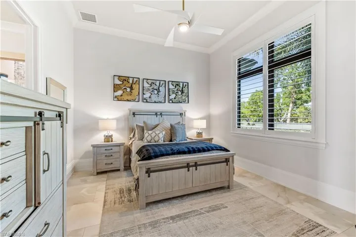 Bedroom featuring ceiling fan and crown molding