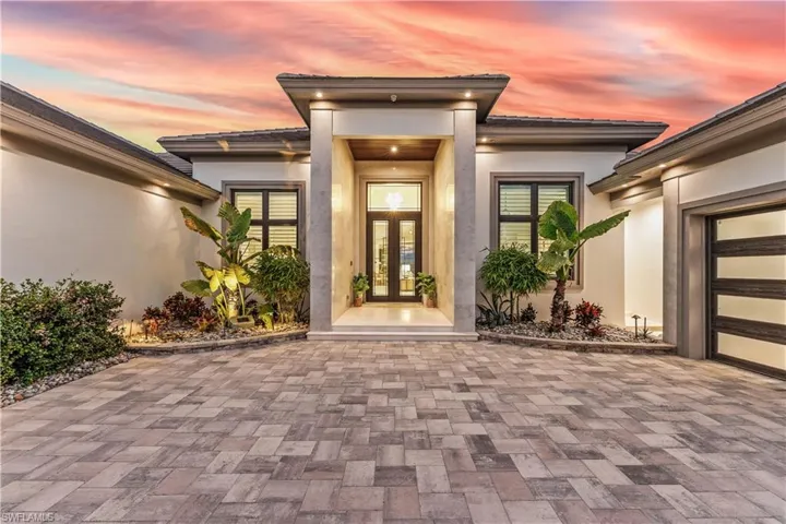 Exterior entry at dusk featuring french doors