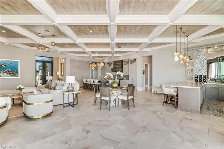 Dining space with beam ceiling, french doors, and coffered ceiling