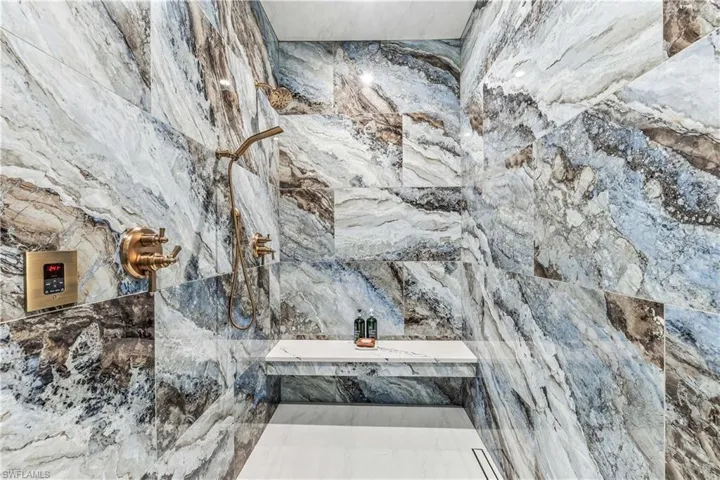 Interior details featuring a tile shower