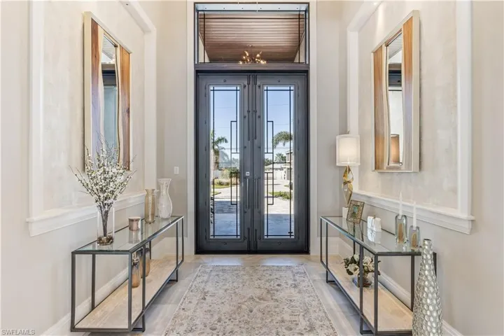 Entrance foyer with a notable chandelier and french doors