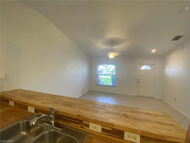 Kitchen overlooks Living Room and features a large counter bar