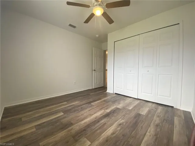 Front Bedroom with LVP flooring, ceiling fan and large closet