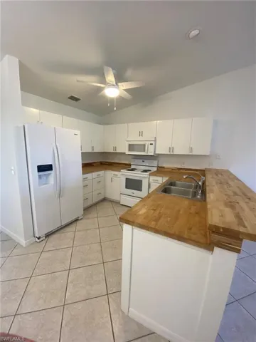 Kitchen features side by side Refrigerator, Range, Microwave Dishwasher and Butcherblock counters!