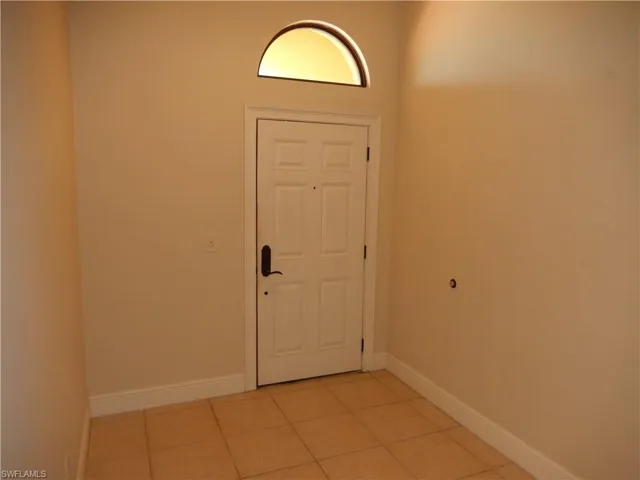 Foyer entrance featuring baseboards and light tile patterned floors
