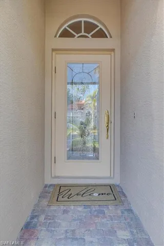Entrance to property with stucco siding