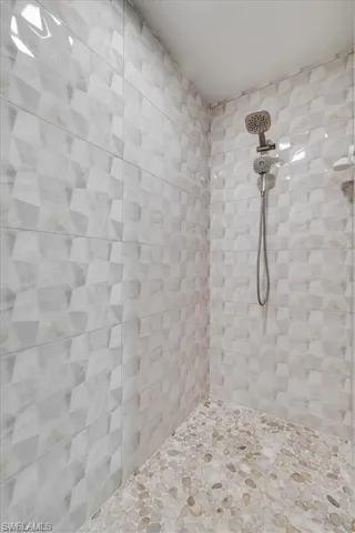 Full bathroom featuring a tile shower